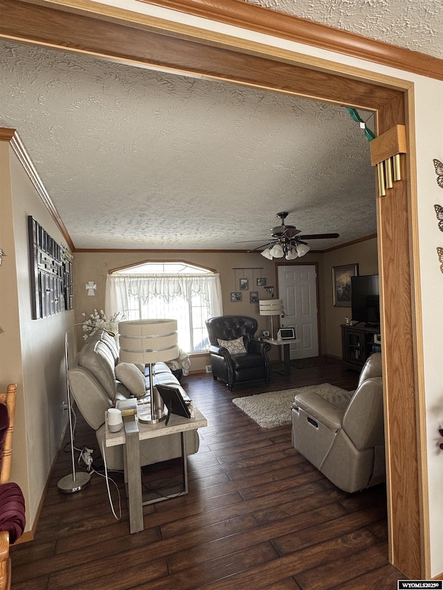 living room featuring ceiling fan, hardwood / wood-style floors, a textured ceiling, and crown molding