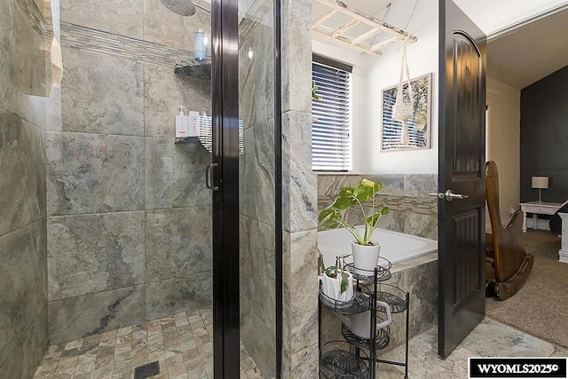 bathroom featuring a stall shower and a garden tub