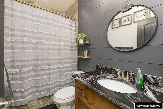 full bathroom with wood walls, vanity, toilet, and a shower with curtain