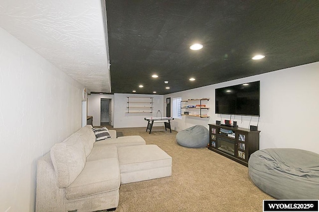 carpeted living room featuring a textured ceiling and recessed lighting