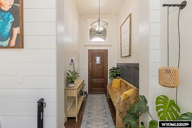 interior space with dark wood-style floors and a notable chandelier