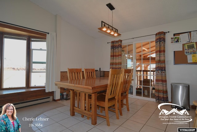 dining area with light tile patterned floors, a baseboard radiator, and lofted ceiling