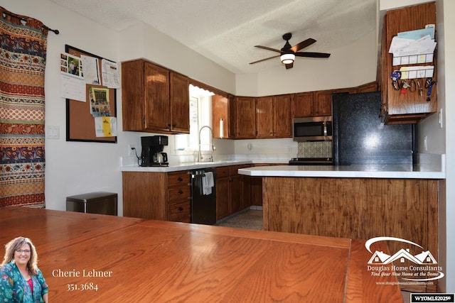 kitchen featuring a textured ceiling, a sink, a ceiling fan, light countertops, and black appliances