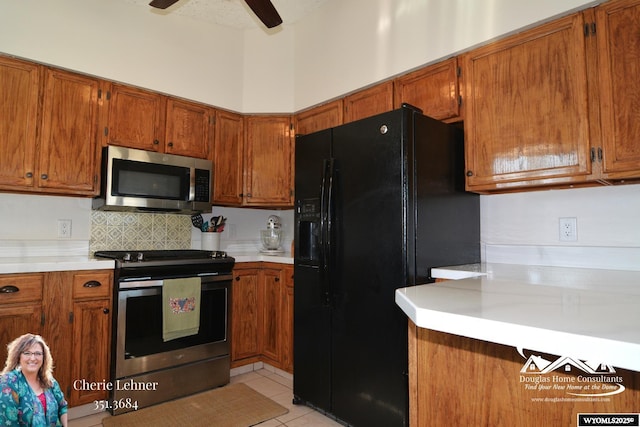 kitchen with brown cabinetry, ceiling fan, stainless steel appliances, and light countertops