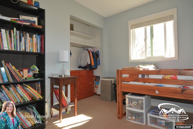 bedroom with a closet and carpet