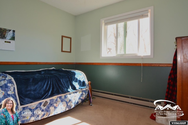 bedroom featuring carpet floors and a baseboard heating unit