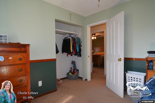 bedroom featuring carpet floors, a closet, baseboards, and a textured ceiling