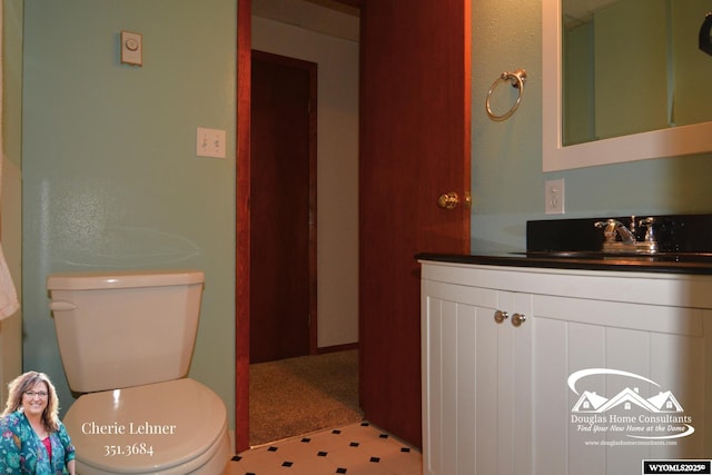 bathroom featuring vanity, toilet, and tile patterned floors