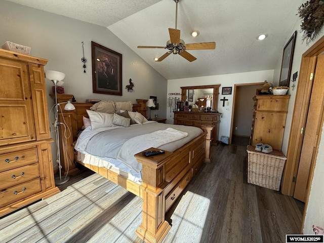 bedroom featuring lofted ceiling, ceiling fan, a textured ceiling, and dark wood-type flooring