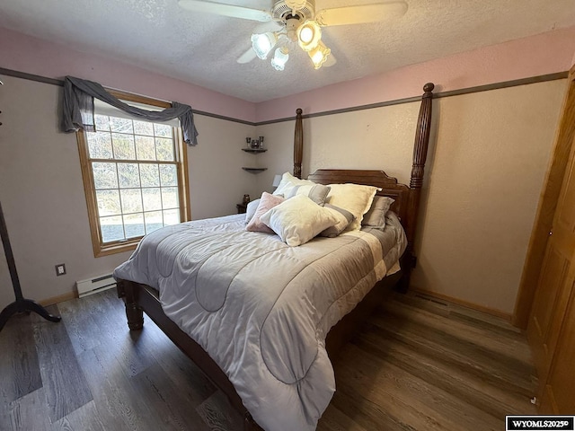 bedroom with a textured ceiling, a baseboard radiator, wood finished floors, and a ceiling fan