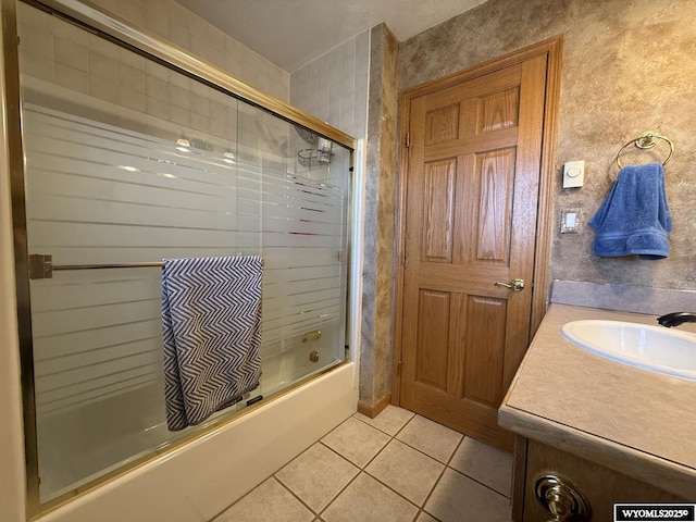 bathroom featuring enclosed tub / shower combo, vanity, and tile patterned floors