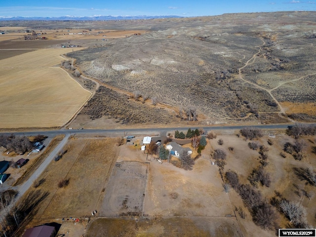 bird's eye view featuring a mountain view, a desert view, and a rural view