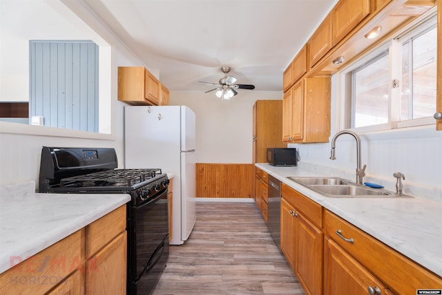 kitchen featuring black gas range oven, a sink, light countertops, and dishwasher