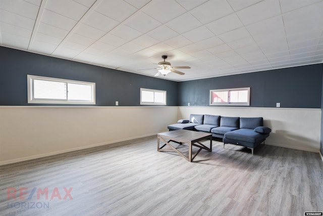 living area featuring ceiling fan, wood finished floors, and baseboards