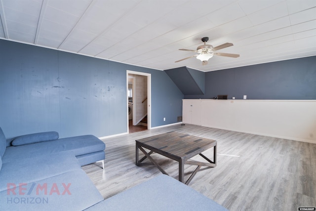 living area with washer / dryer, baseboards, ceiling fan, wood finished floors, and stairs