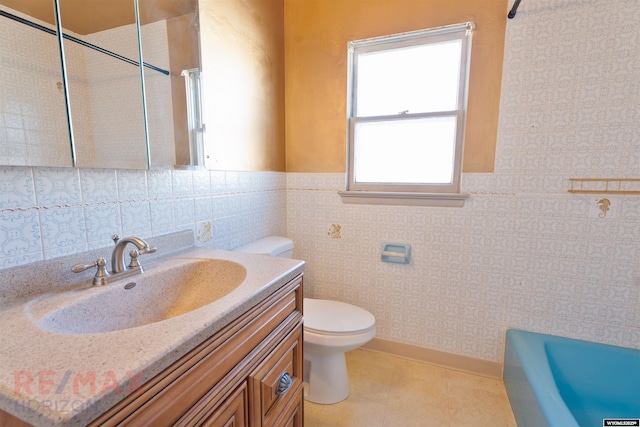 bathroom featuring a bathing tub, toilet, a wainscoted wall, vanity, and a shower