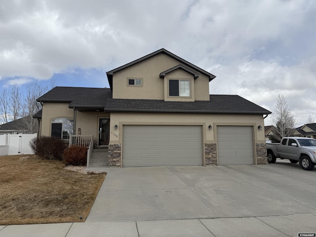 view of front of property with driveway, stone siding, and stucco siding