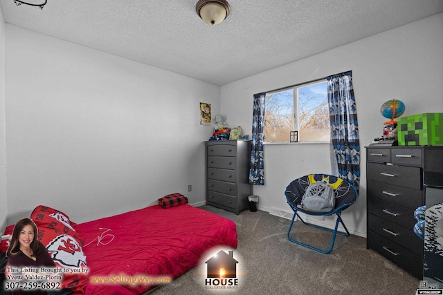 carpeted bedroom with a textured ceiling and baseboards