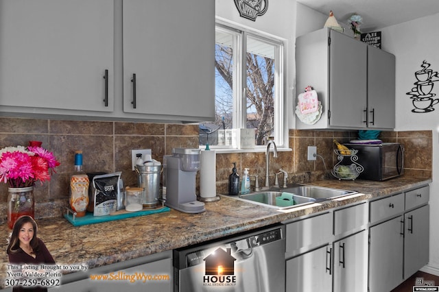 kitchen with dishwasher, decorative backsplash, and a sink