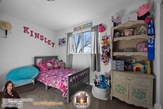 bedroom featuring a textured ceiling and carpet