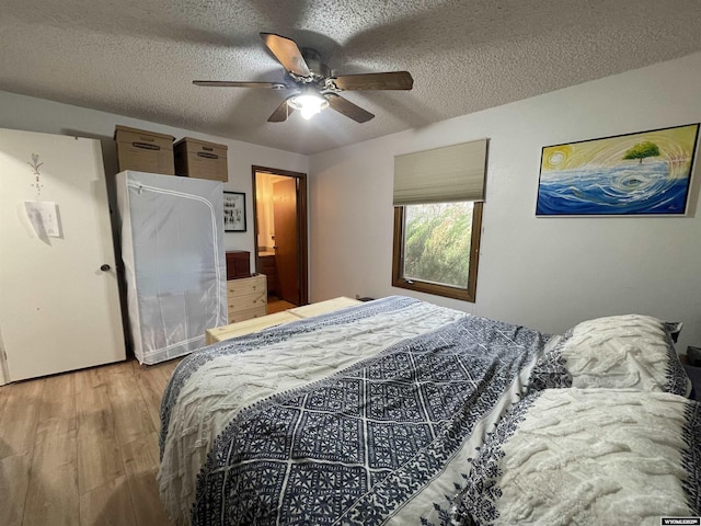 bedroom featuring ceiling fan, a textured ceiling, and light wood finished floors