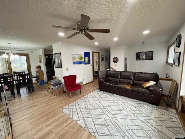 living area with visible vents, light wood-style flooring, and recessed lighting