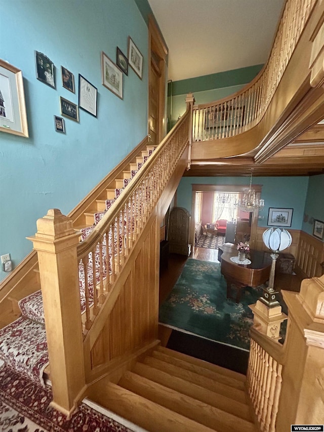 stairway featuring a towering ceiling