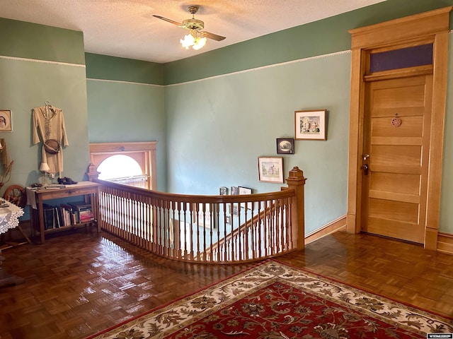 hall with a textured ceiling