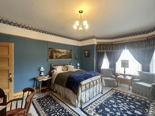 carpeted bedroom with a notable chandelier and baseboards