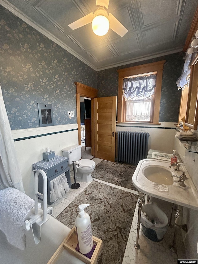 miscellaneous room featuring wallpapered walls, wainscoting, radiator, an ornate ceiling, and a sink