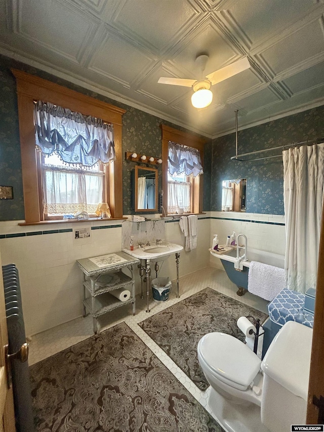 bathroom featuring an ornate ceiling, curtained shower, a wealth of natural light, and wallpapered walls