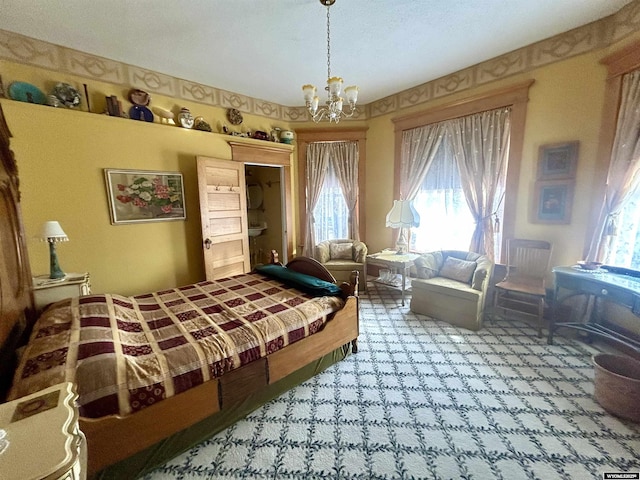 bedroom with an inviting chandelier and multiple windows