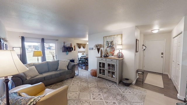 living area with light wood-style flooring and a textured ceiling