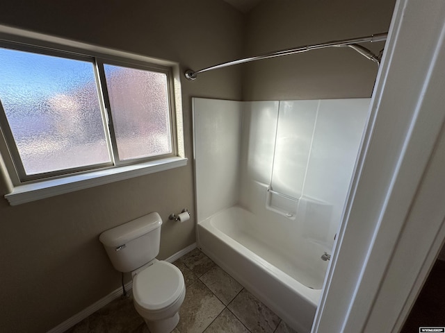 full bathroom with shower / bathing tub combination, tile patterned flooring, toilet, and baseboards