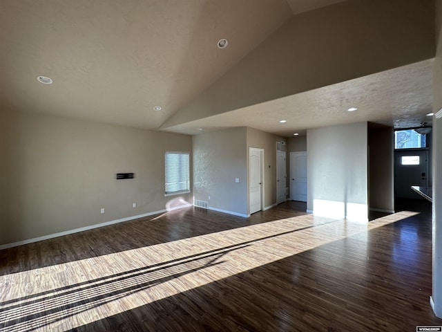 unfurnished room featuring a textured ceiling, recessed lighting, wood finished floors, visible vents, and baseboards