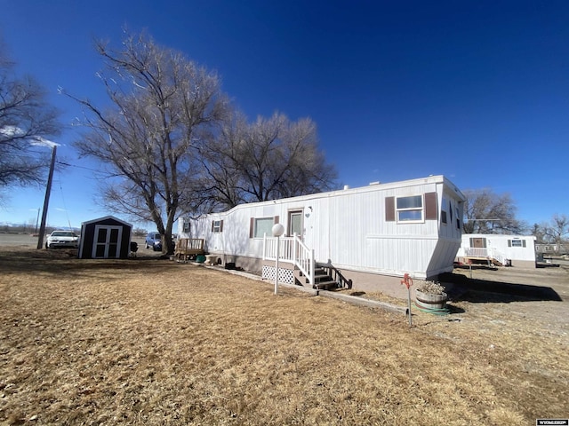 manufactured / mobile home featuring a storage unit and an outbuilding