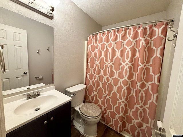 bathroom featuring toilet, a shower with curtain, wood finished floors, a textured ceiling, and vanity