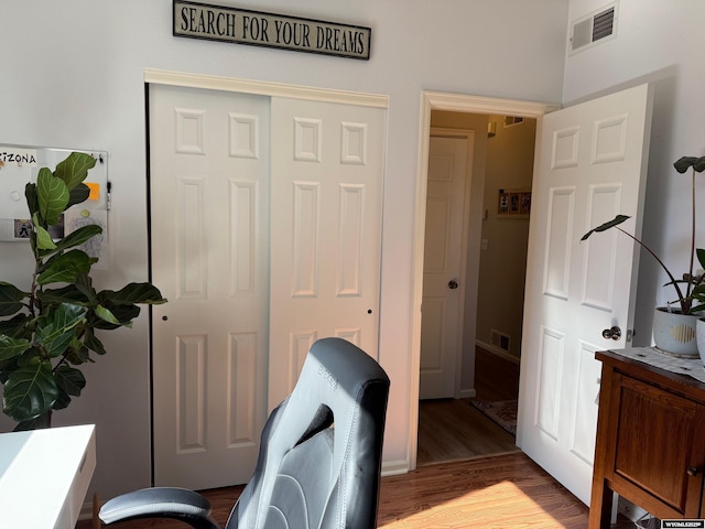 home office featuring wood finished floors and visible vents