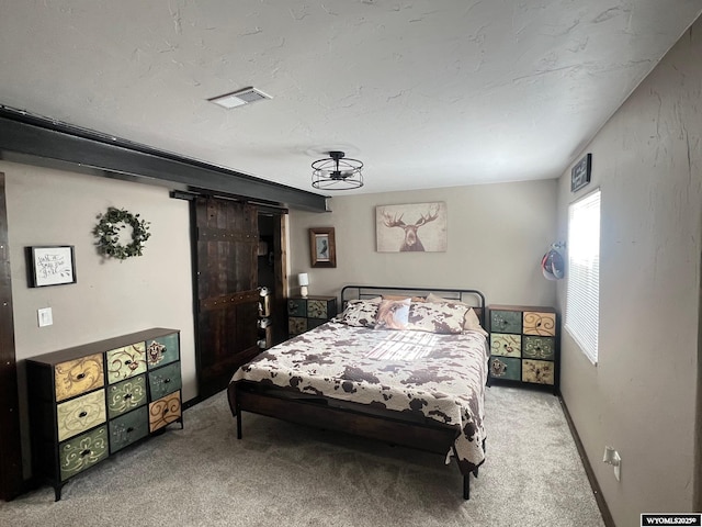 bedroom featuring a textured ceiling, carpet floors, visible vents, and baseboards