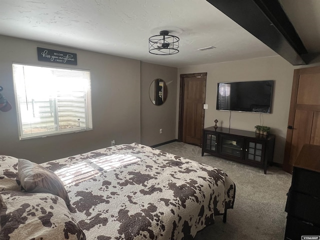 carpeted bedroom with visible vents and baseboards