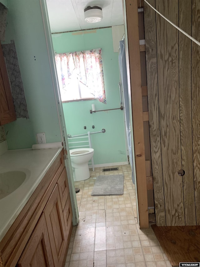 full bath featuring visible vents, vanity, toilet, and tile patterned floors