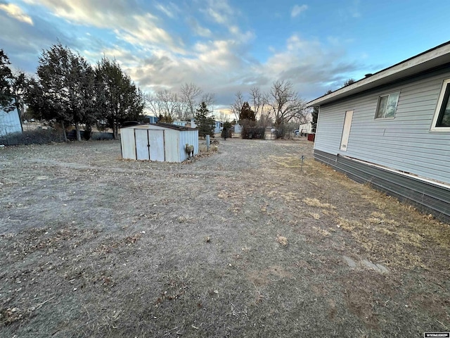 view of yard with a storage shed and an outdoor structure