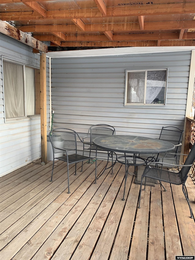 wooden terrace with outdoor dining area