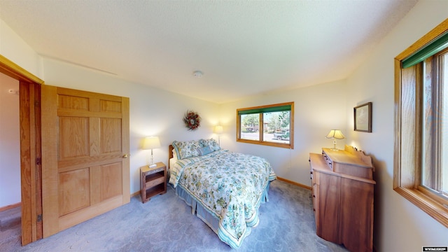 carpeted bedroom featuring baseboards