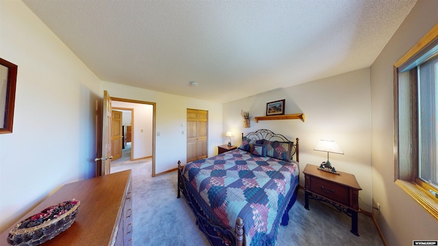 bedroom featuring a textured ceiling, carpet flooring, and baseboards