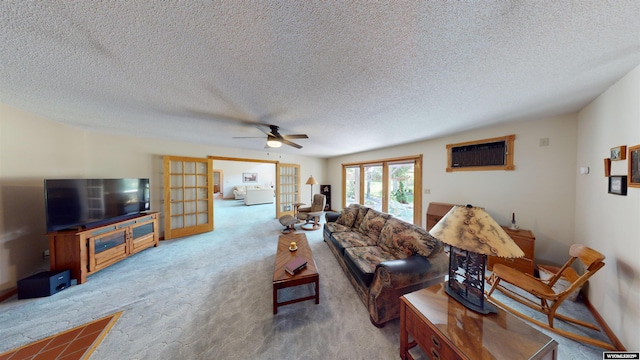 living area with a textured ceiling, a ceiling fan, french doors, a wall mounted AC, and carpet