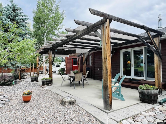 view of patio featuring french doors, a pergola, and outdoor dining space