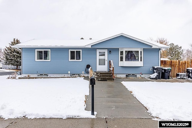 view of front of home featuring entry steps and fence