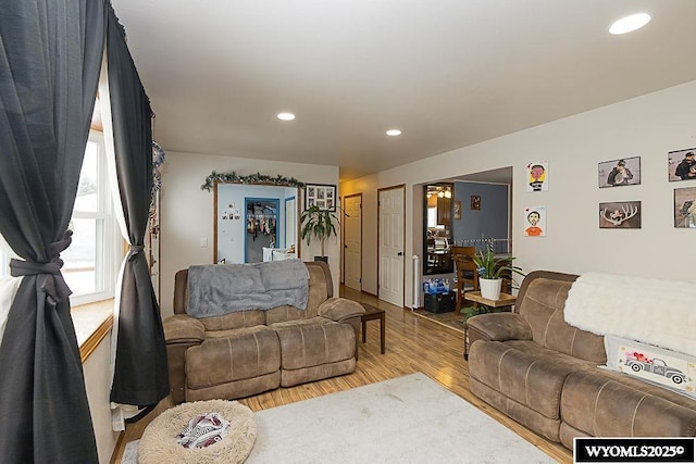 living room with wood finished floors and recessed lighting