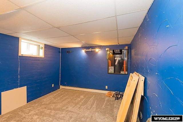 basement featuring carpet flooring and a drop ceiling